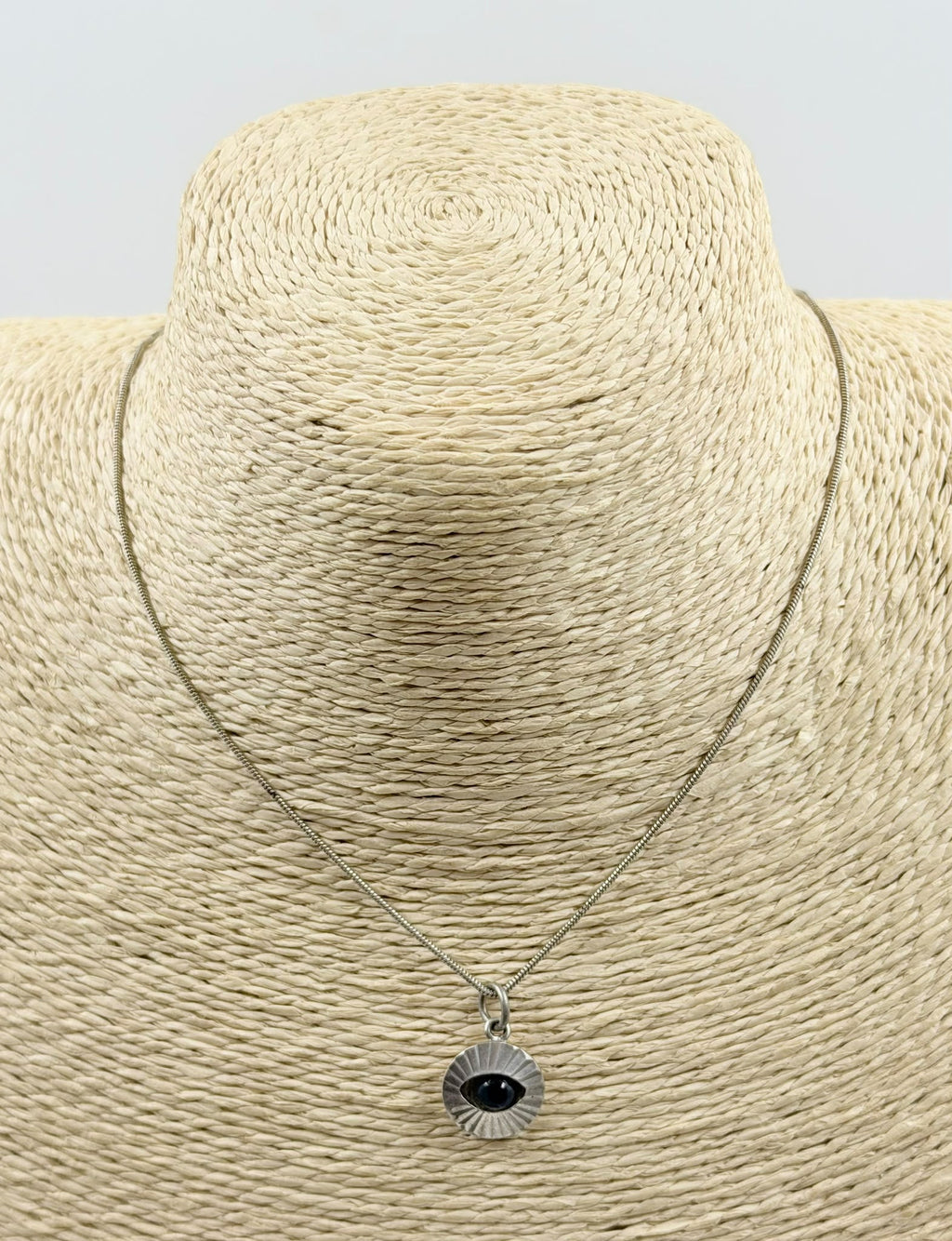 Evil eye necklace on jewelry bust - front view