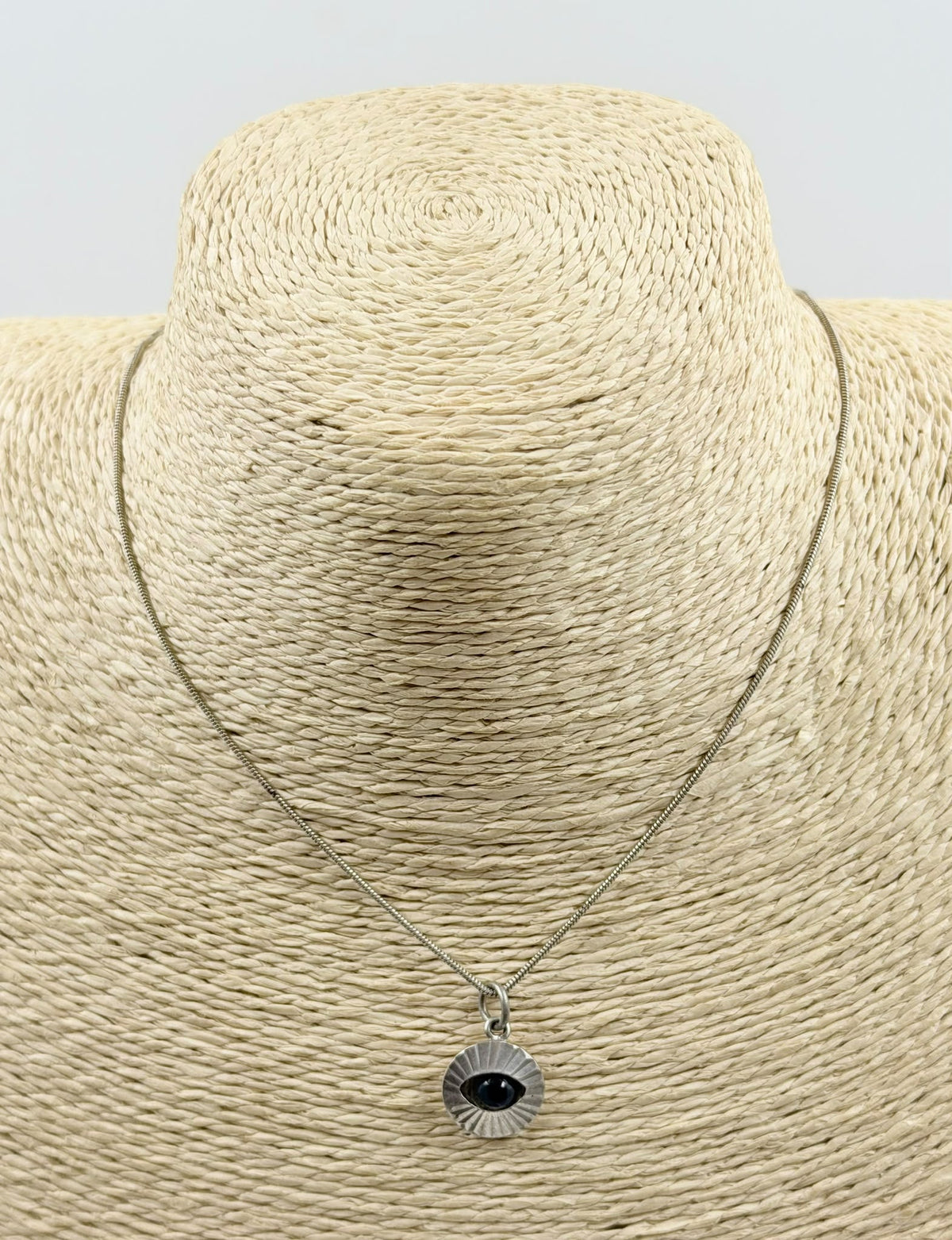 Evil eye necklace on jewelry bust - front view