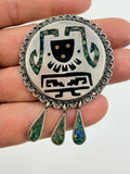 Vintage silver brooch held in hand - side view