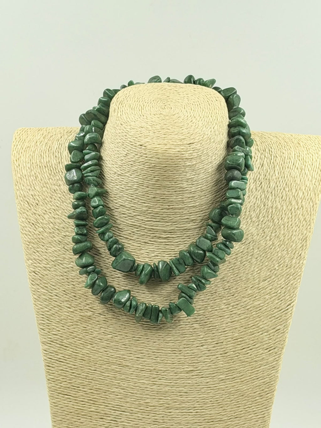 Green aventurine chips held in hand showing stone size and color