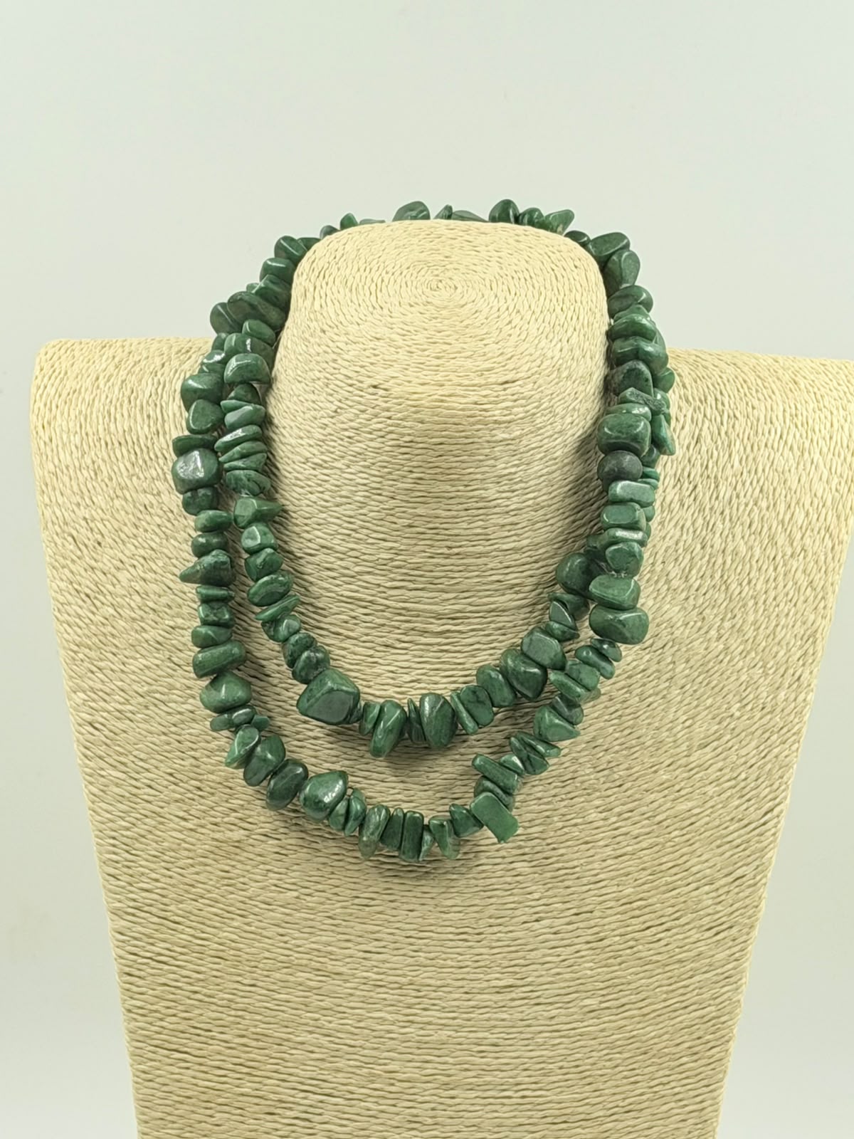 Green aventurine chips held in hand showing stone size and color