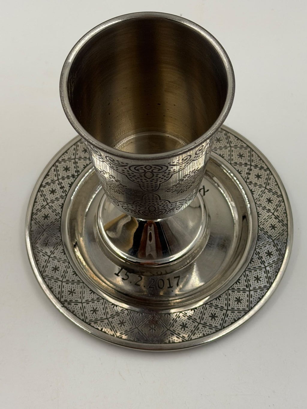 Israeli silver-plated Kiddush cup and saucer set three-quarter angle showing full arabesque engraving pattern