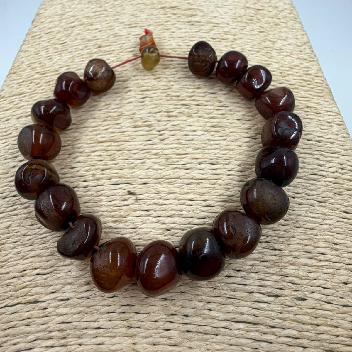 Natural suleimani agate bracelet in hand showing two rows of tumbled beads and stopper detail