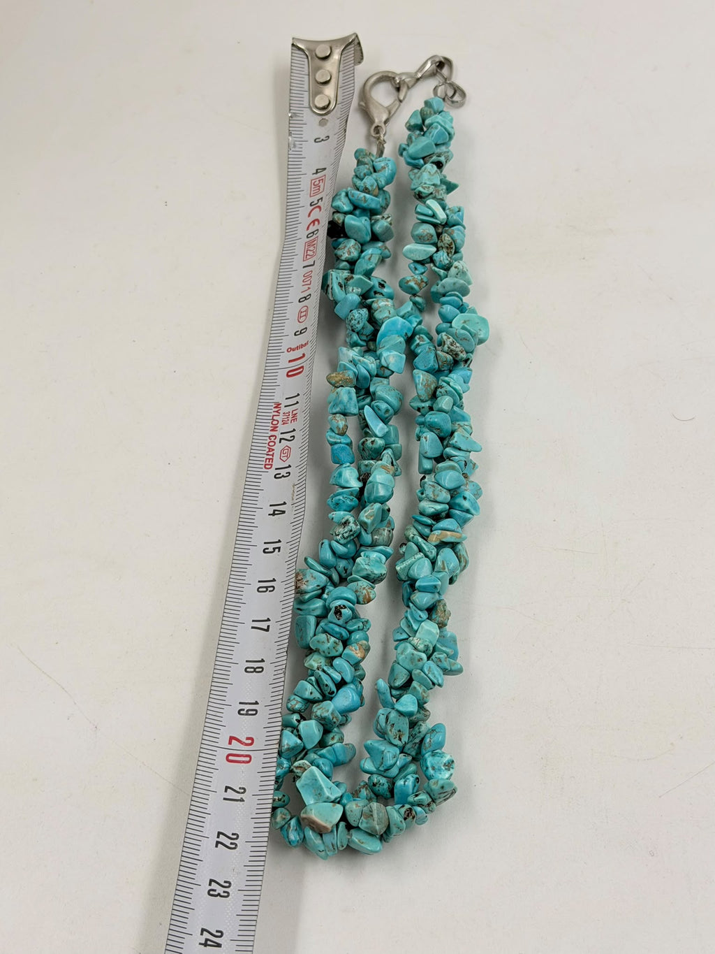Triple strand turquoise necklace displayed on jewelry bust