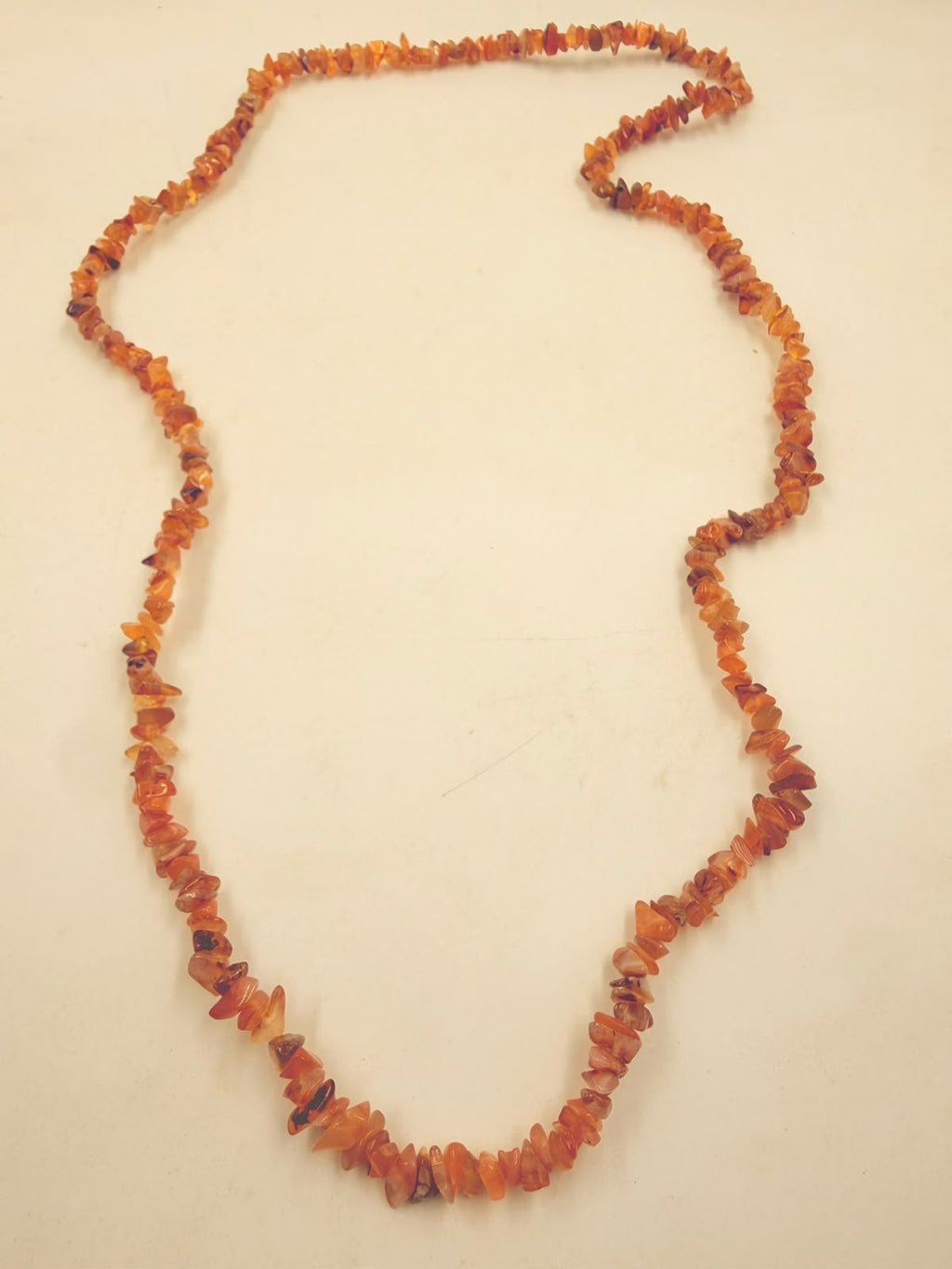 Natural carnelian chip bead necklace macro detail showing translucency and brown natural inclusions