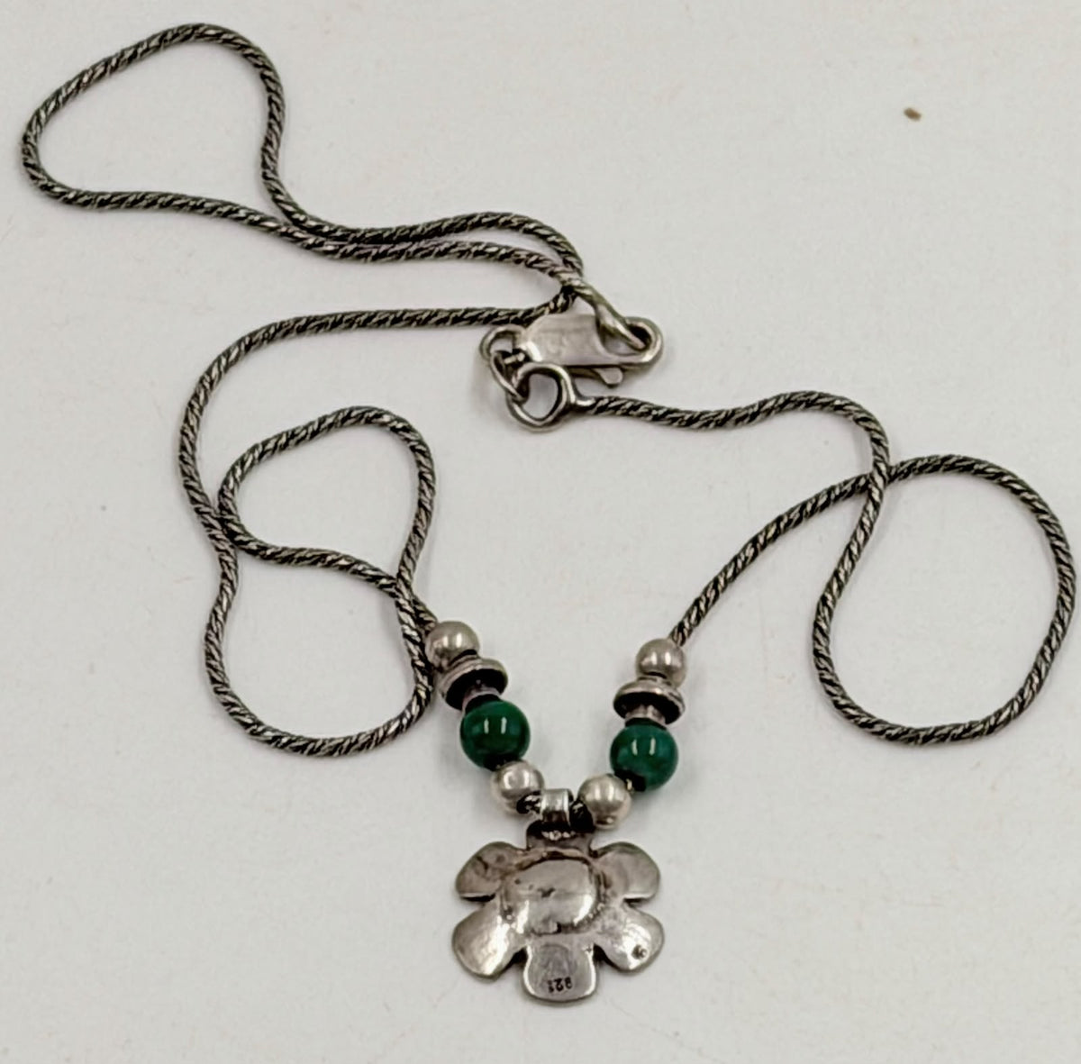 Back of flower pendant showing 925 hallmark