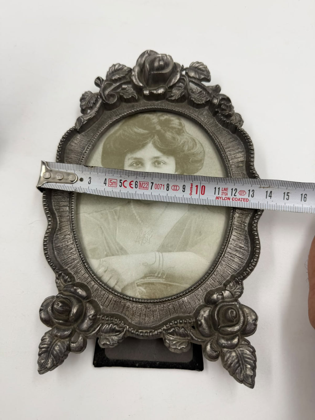 Pewter photo frame decorative feet detail