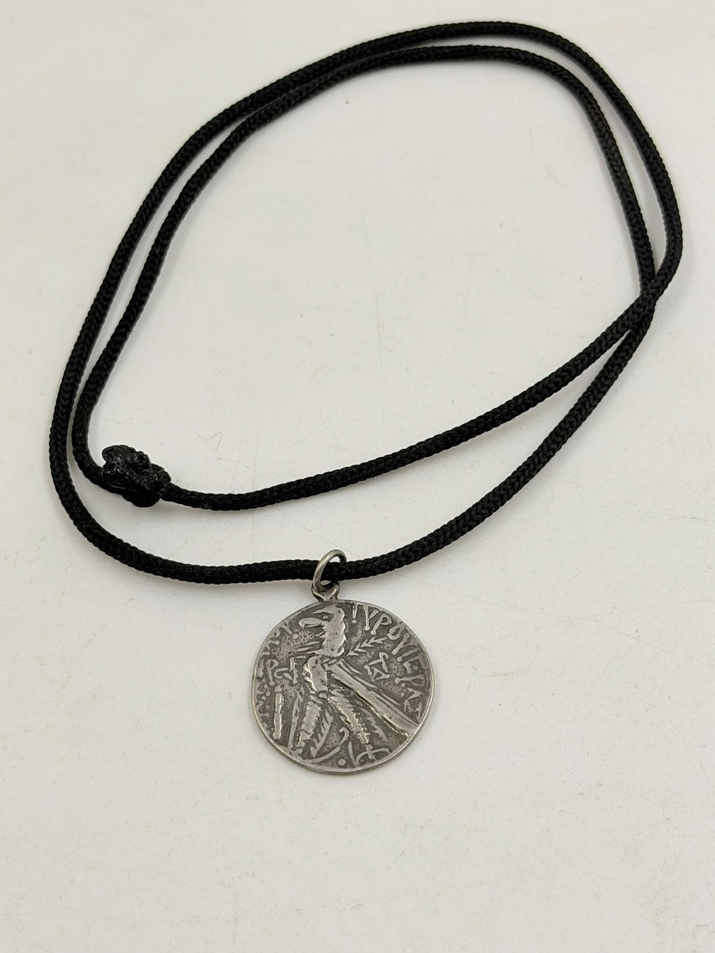 800 silver antique Roman coin pendant close-up in hand