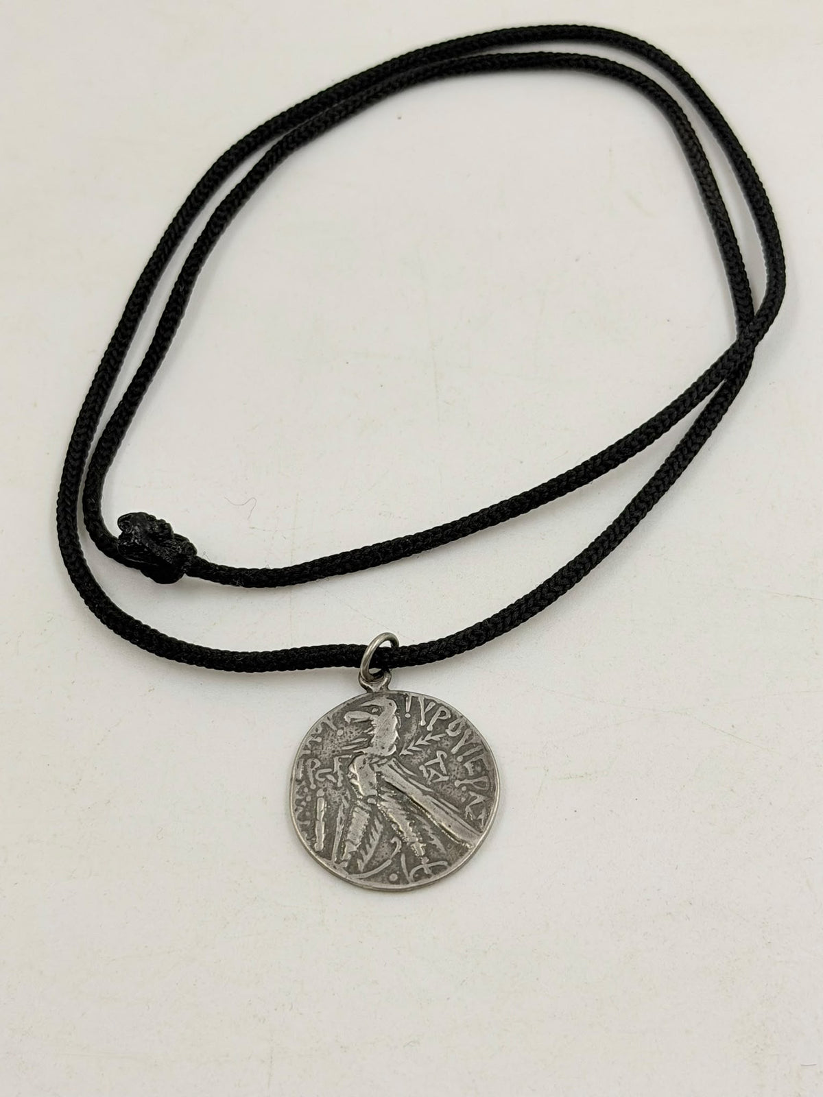 800 silver antique Roman coin pendant close-up in hand