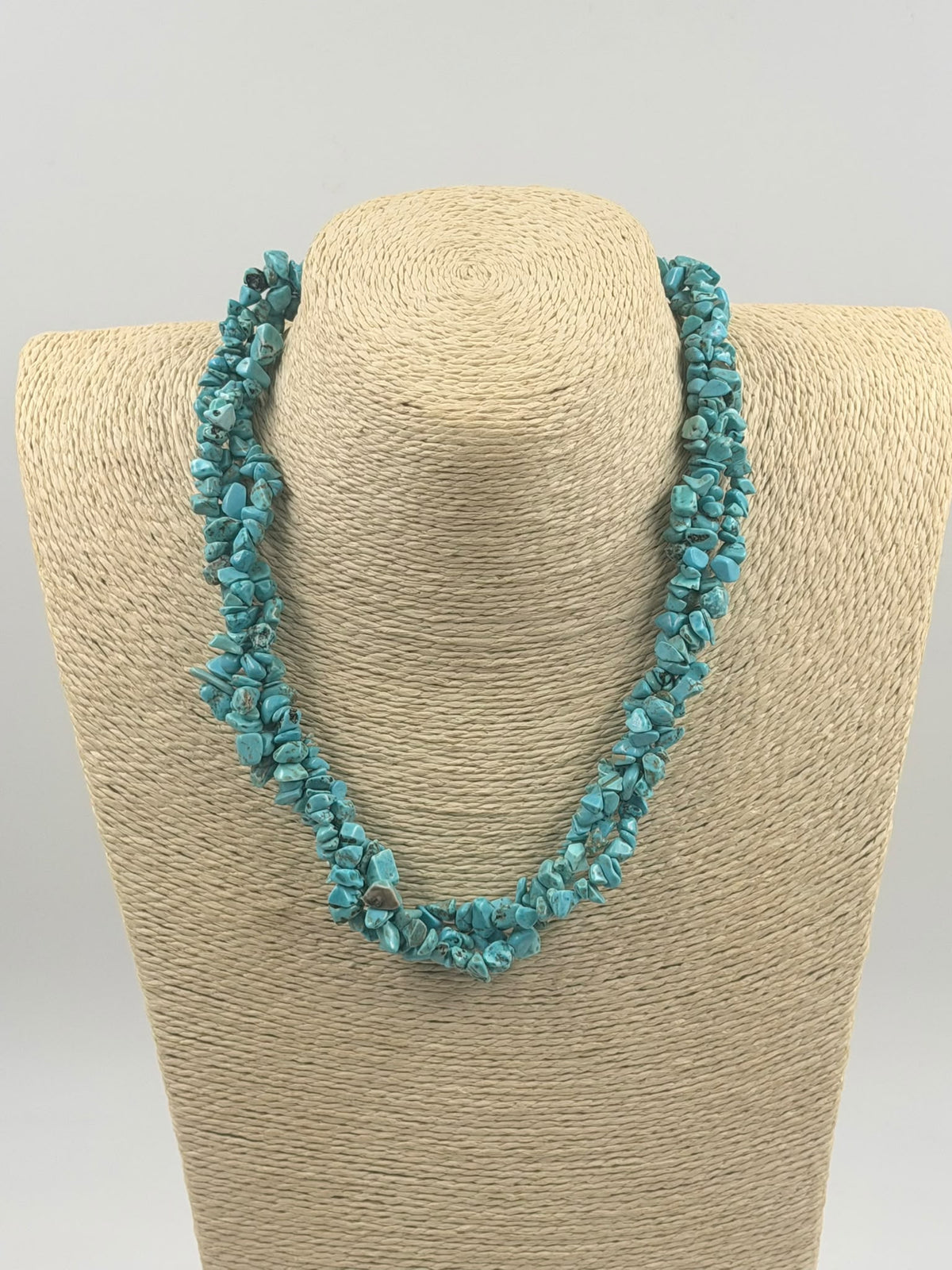Turquoise necklace next to ruler showing 22cm length