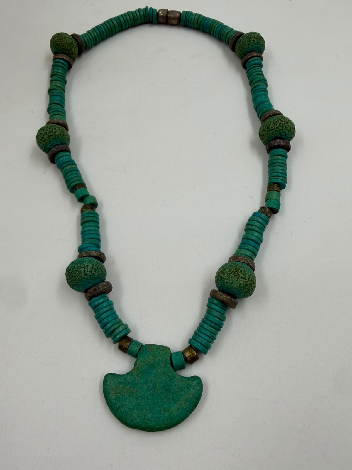 Vintage style natural turquoise tribal necklace full view on white background showing heishi disc beads and fan pendant