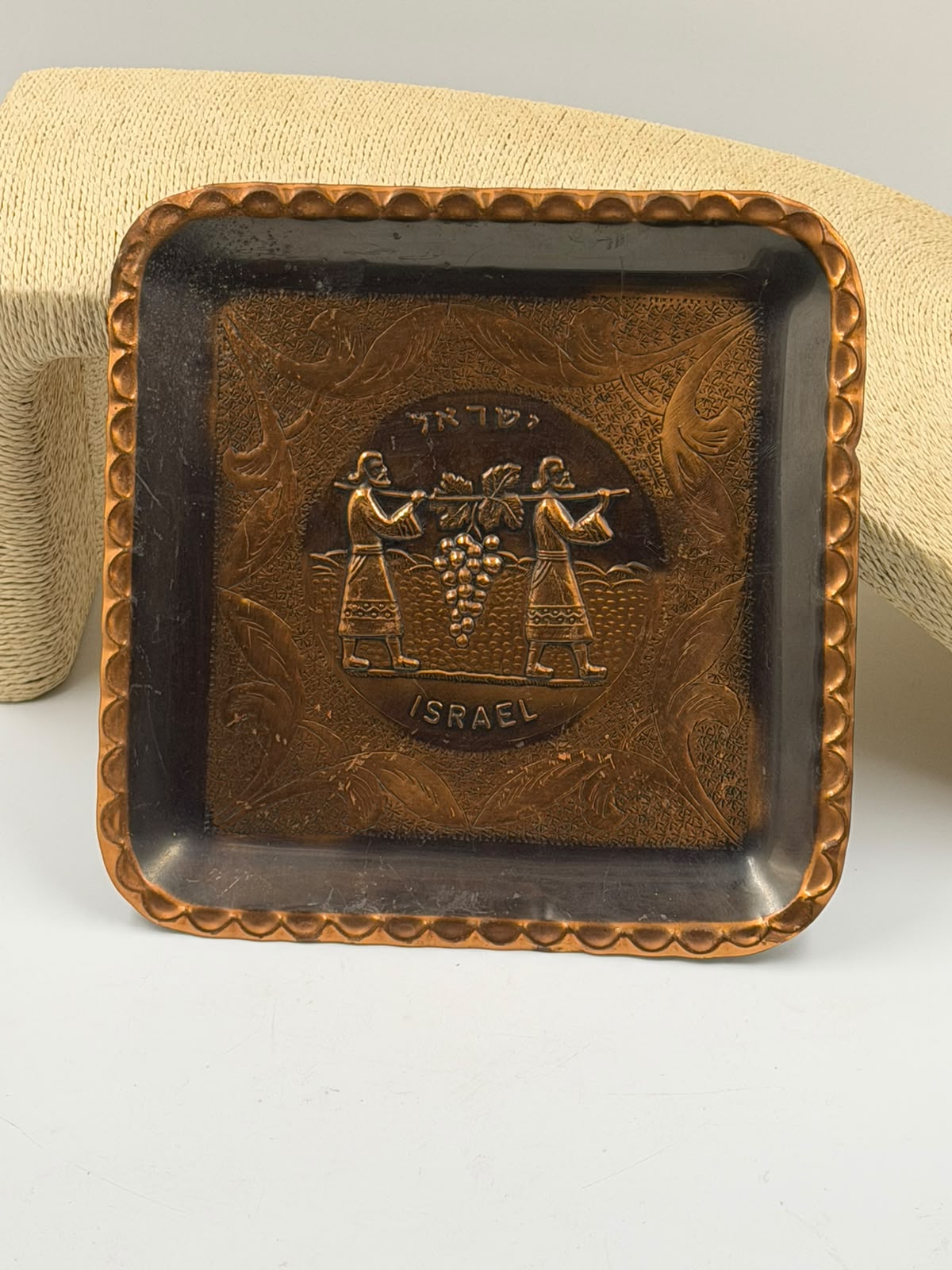Top-down view of Israeli copper tray showing full scalloped border design