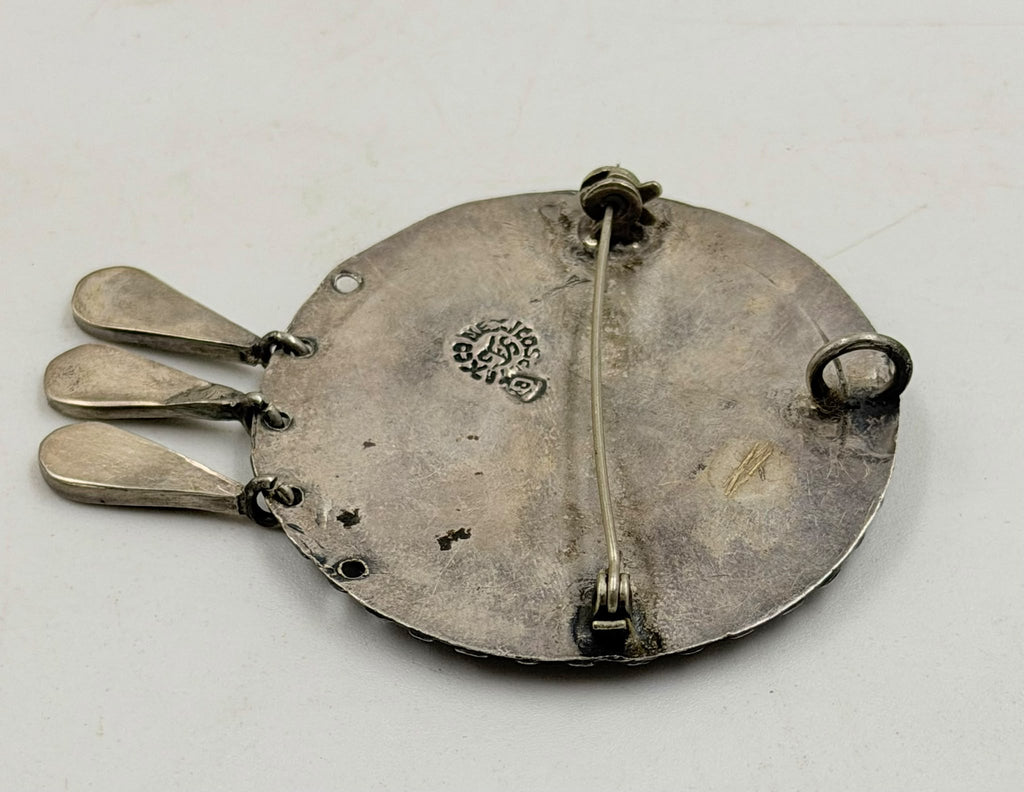 Brooch on flat surface