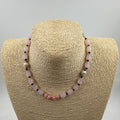 Rose quartz garnet bracelet held in palm showing full length 20cm with silver-tone tube spacers and 925 clasp