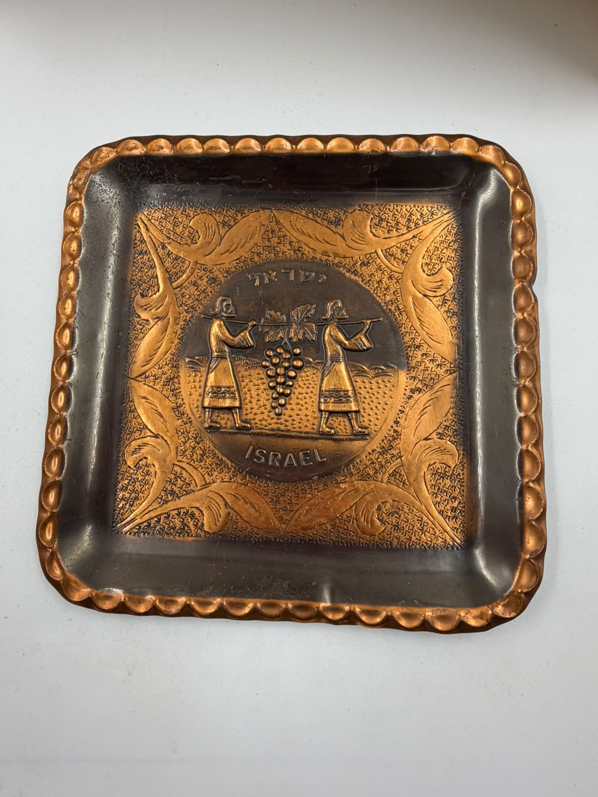 Israeli copper tray held in hand showing size reference – approx. 20cm