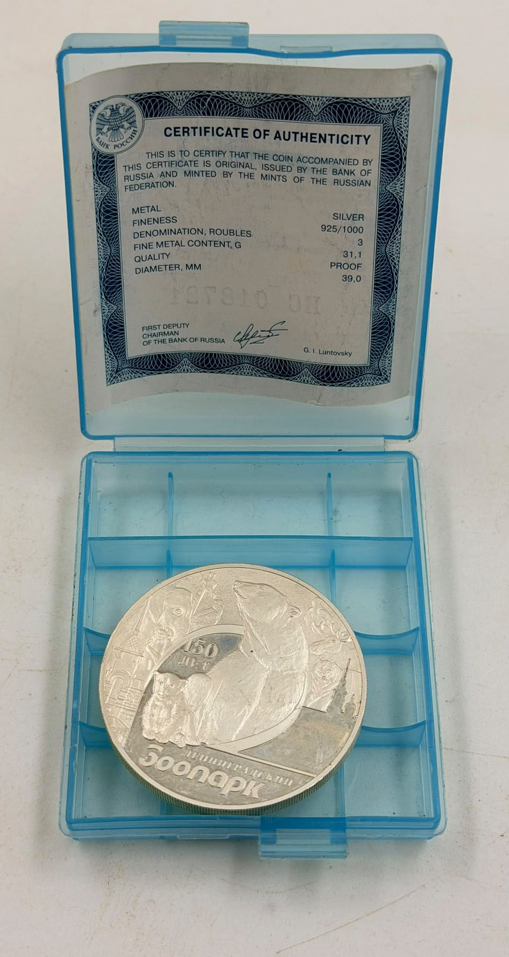 Coin in original blue plastic presentation case with COA - front view