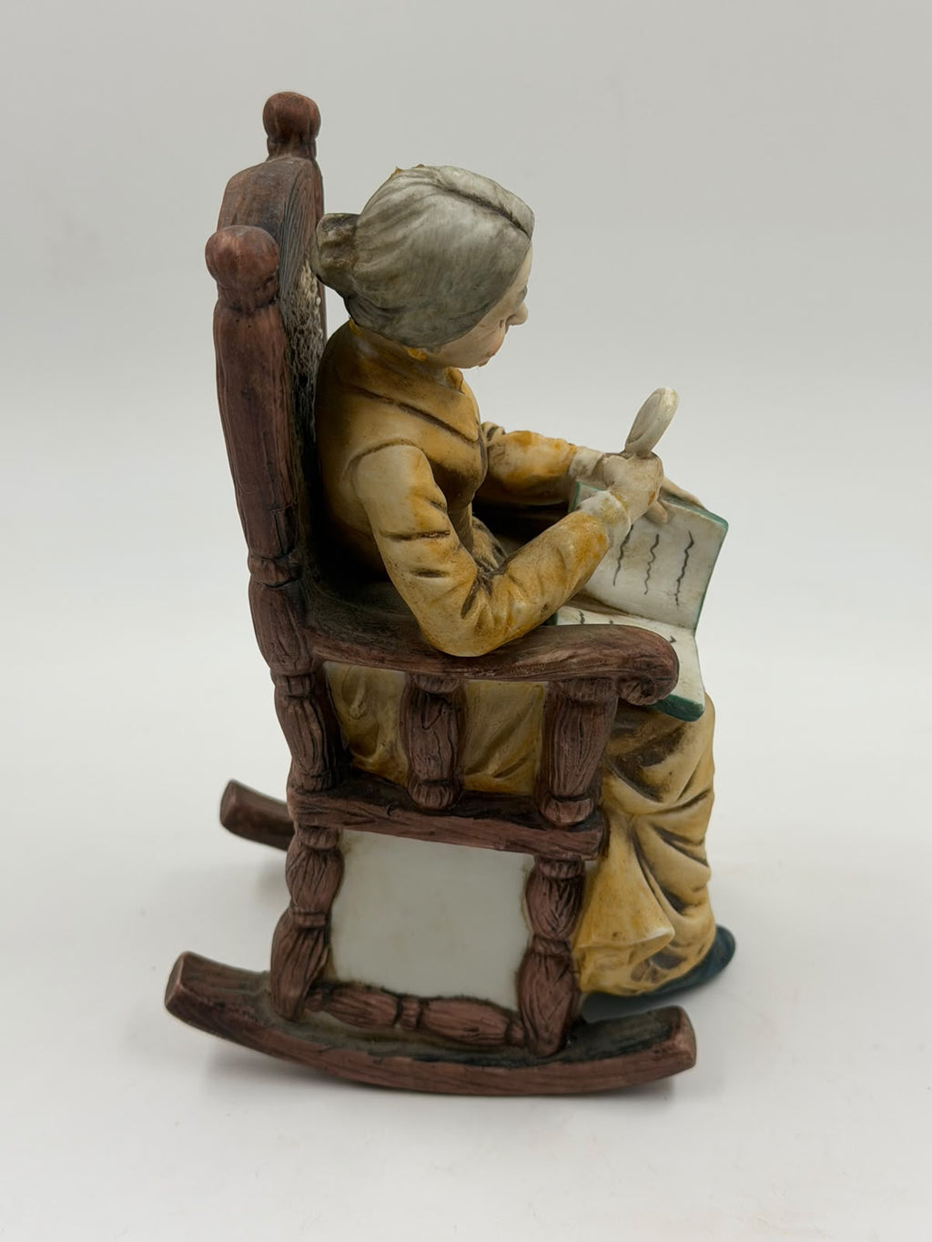 Vintage resin grandma reading figurine front full view showing rocking chair