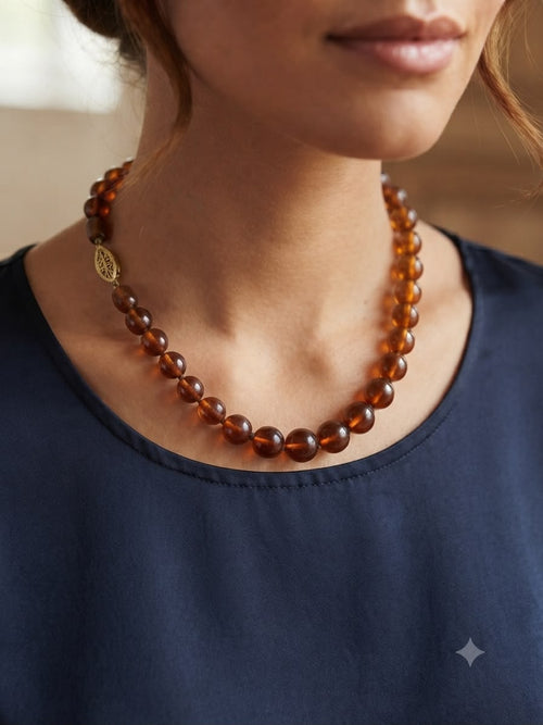 Amber graduated bead necklace on display stand - full view