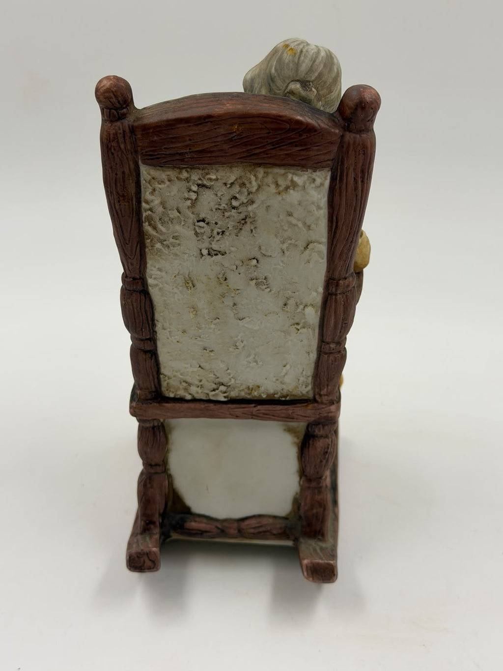 Vintage resin grandma reading figurine three-quarter view