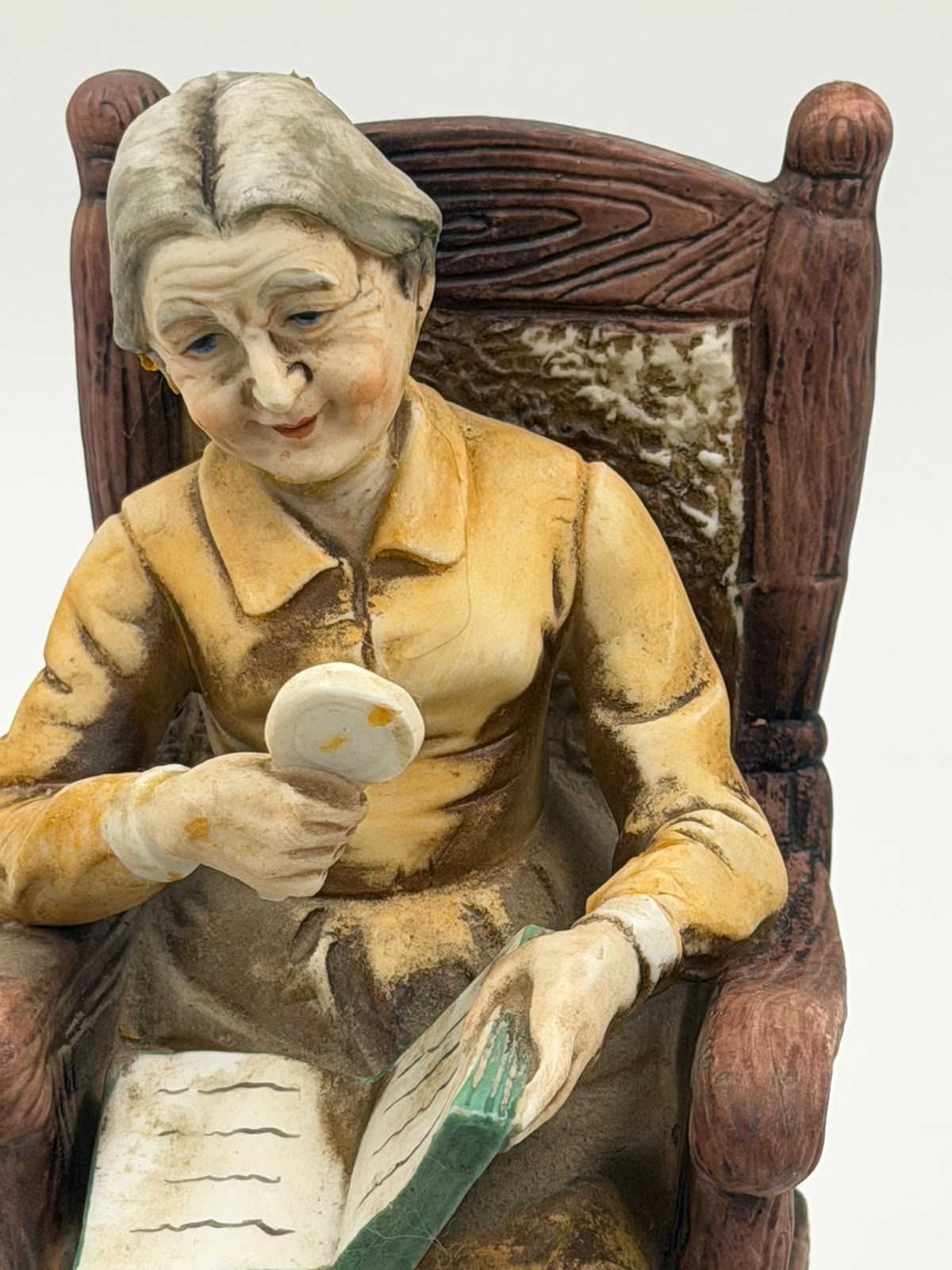 Vintage resin grandma reading figurine full view showing complete rocking chair