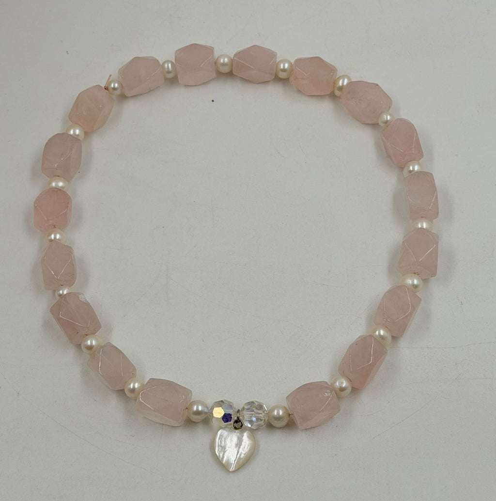 Close-up of crystal AB beads and mother of pearl heart pendant