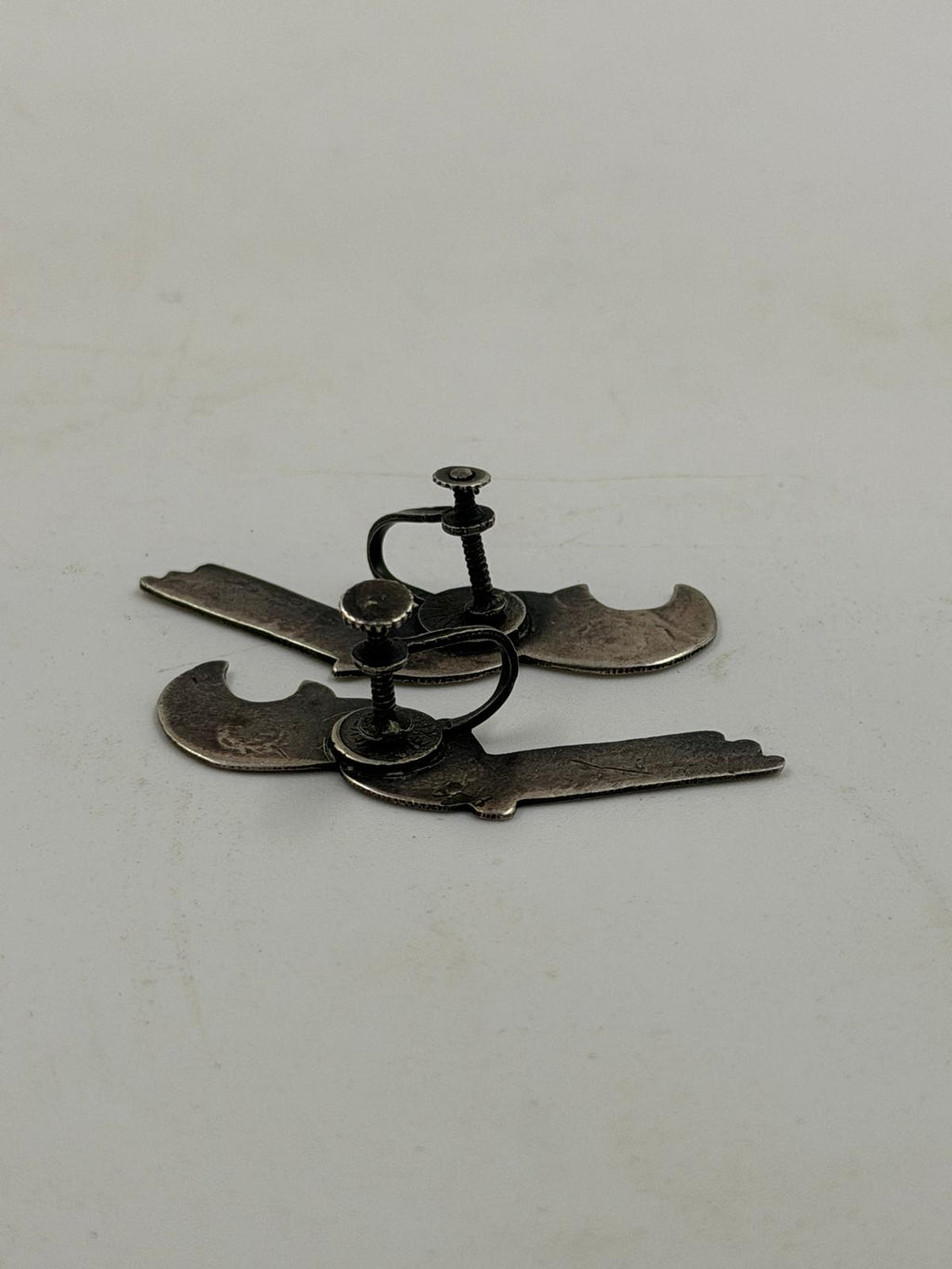 Both earrings laid flat showing front design