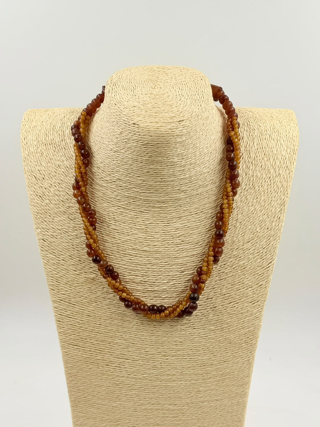 Triple-strand amber necklace on display bust front view