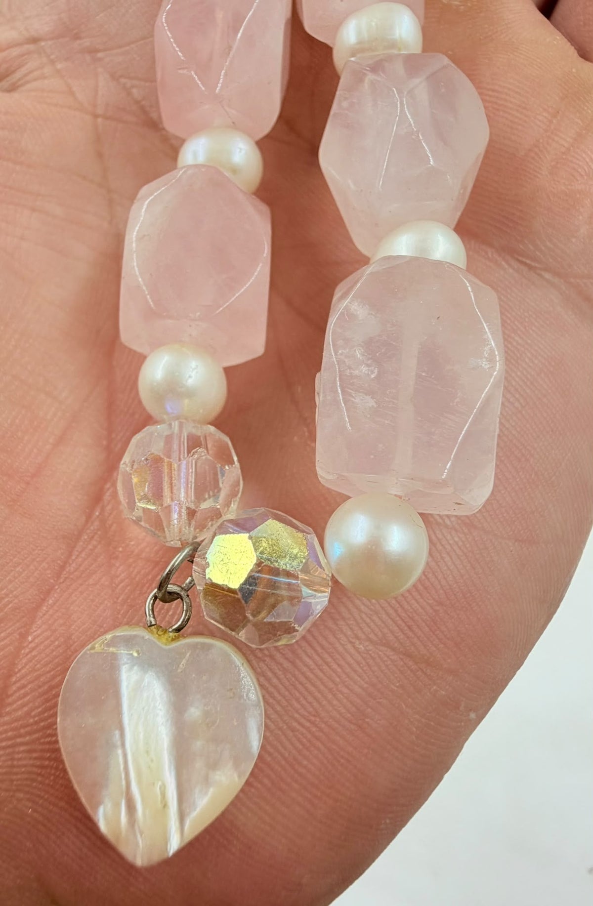 Close-up of mother of pearl heart charm detail