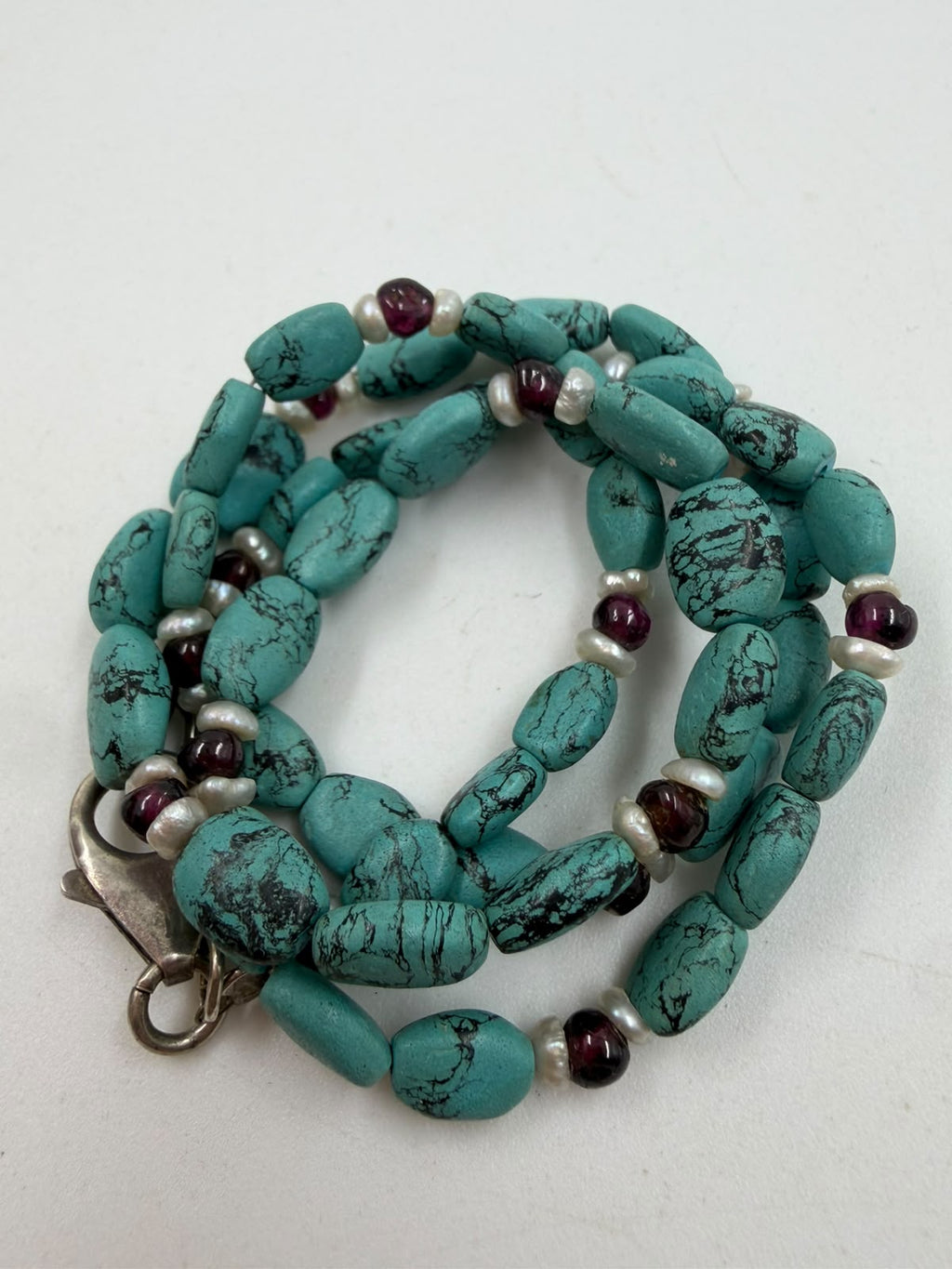 Natural turquoise nugget garnet pearl necklace coiled view showing 925 silver lobster clasp