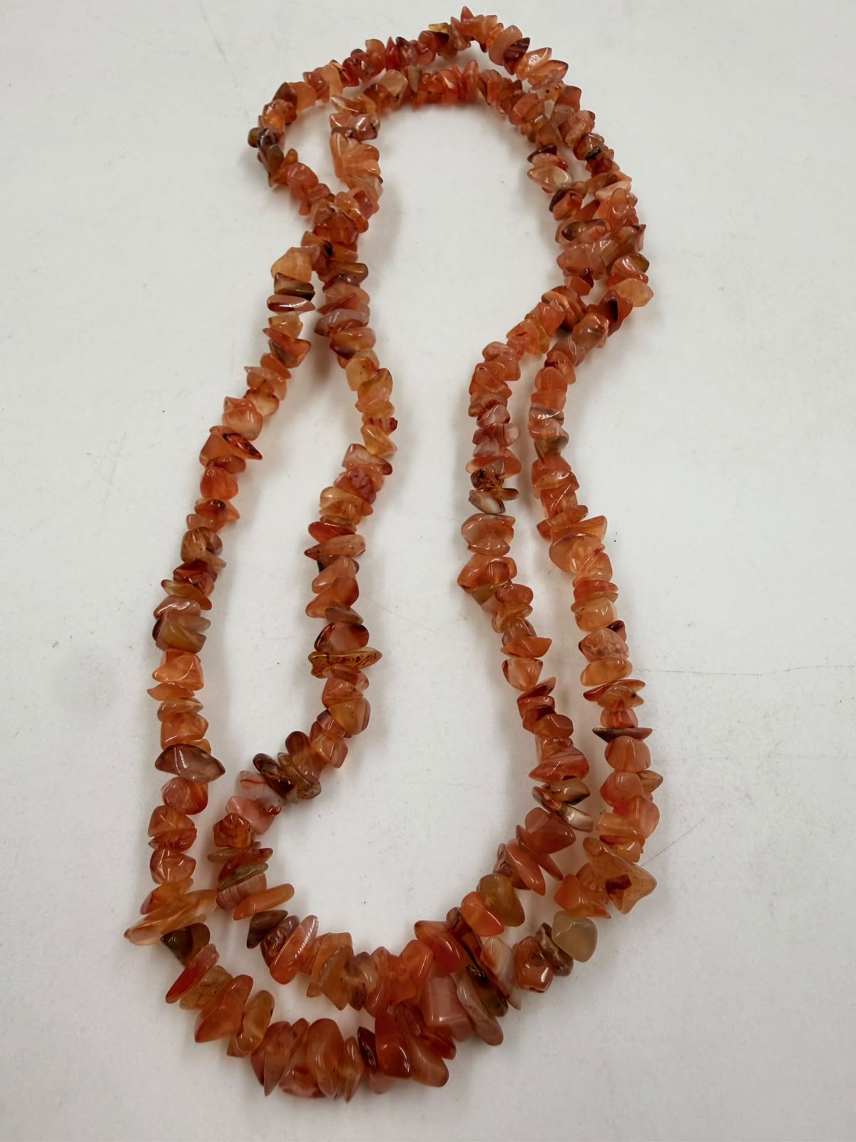Natural carnelian chip necklace close-up showing polished chip bead texture and color variation