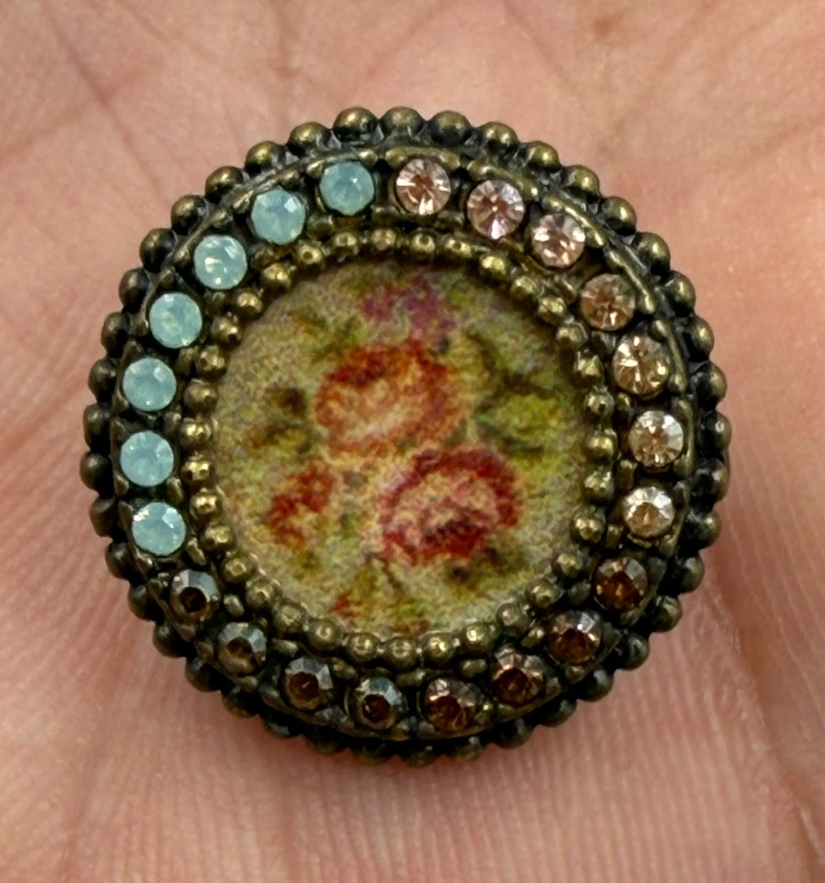 Vintage floral brooch front view on flat surface