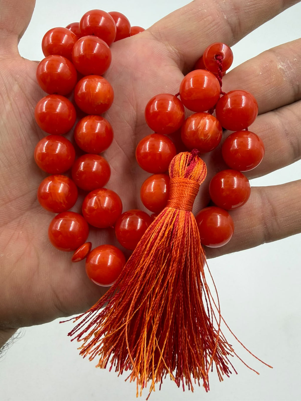 Macro close-up of Turkish Faturan beads showing deep red-orange color and inner translucency