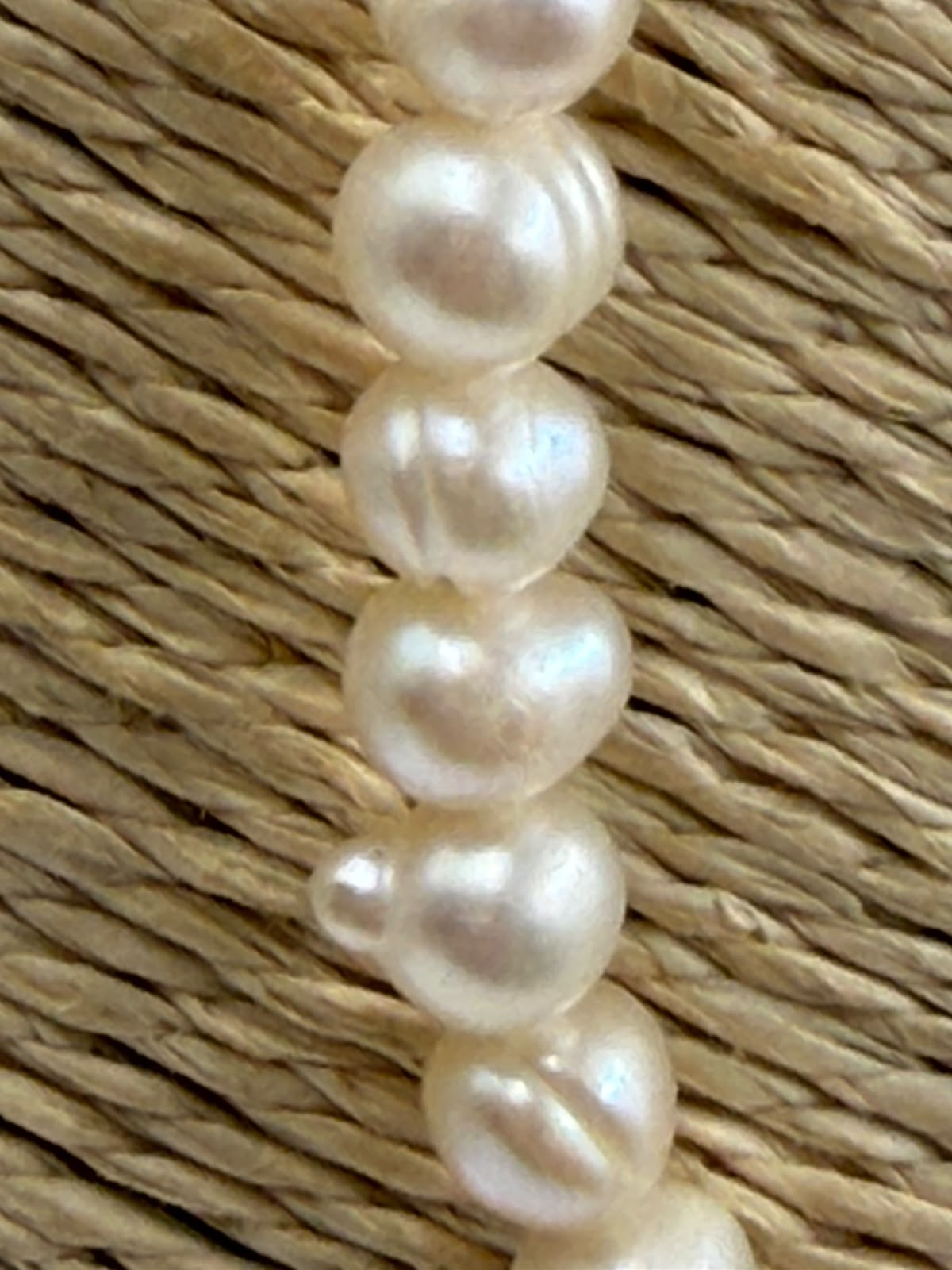 Freshwater pearl necklace detail showing irregular baroque bead shapes and warm white cream tones