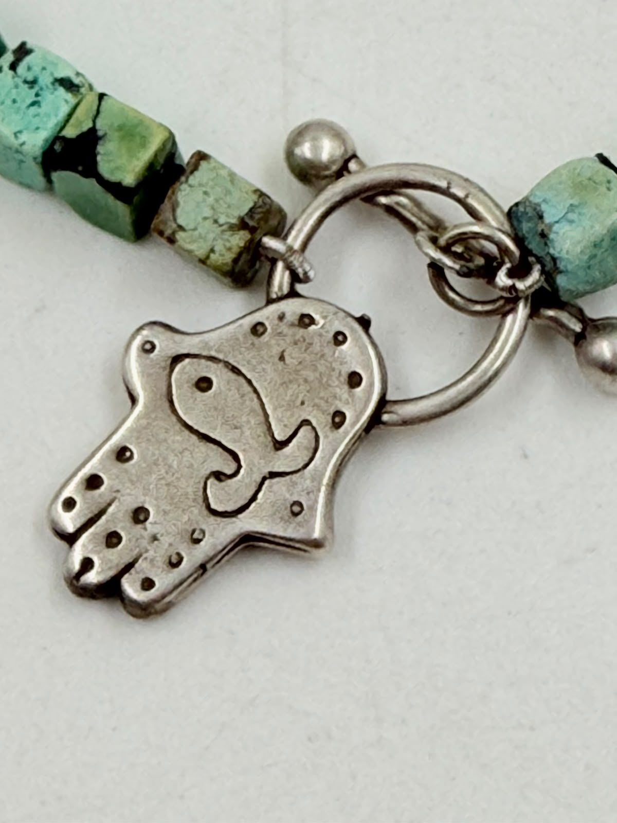 Turquoise bracelet held in hand