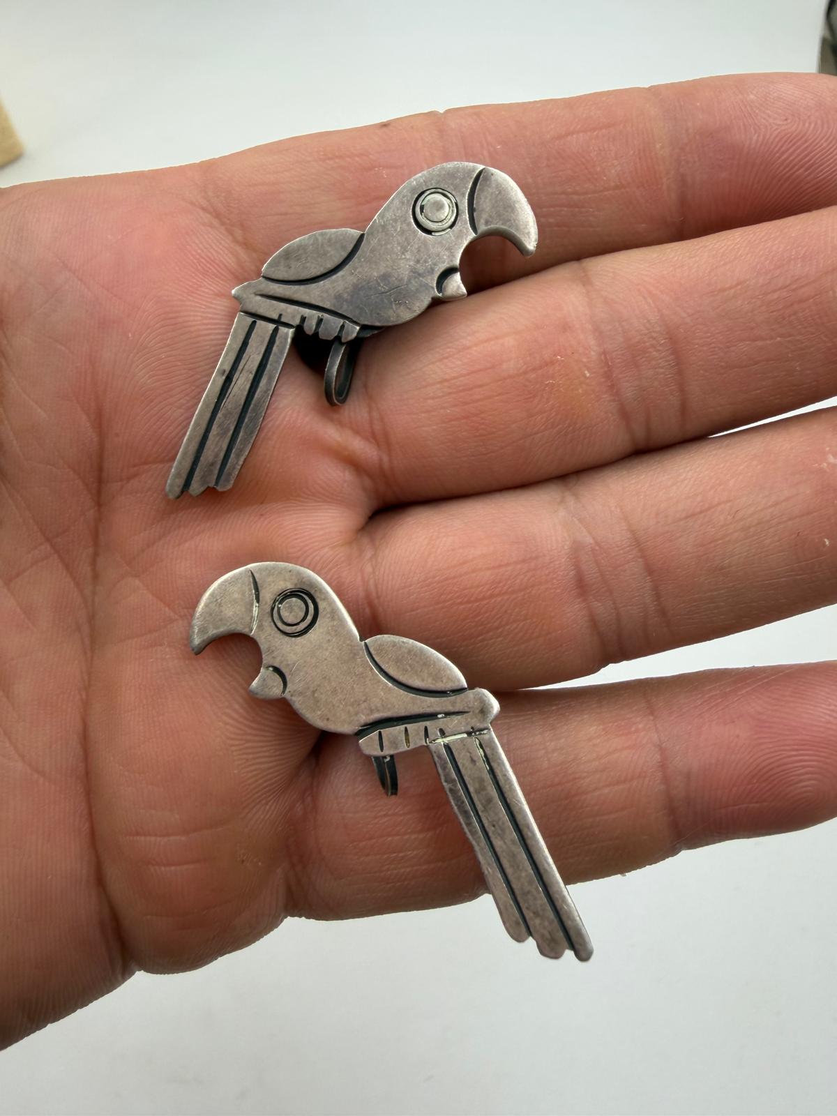 Earrings in hand showing back with screw mechanism