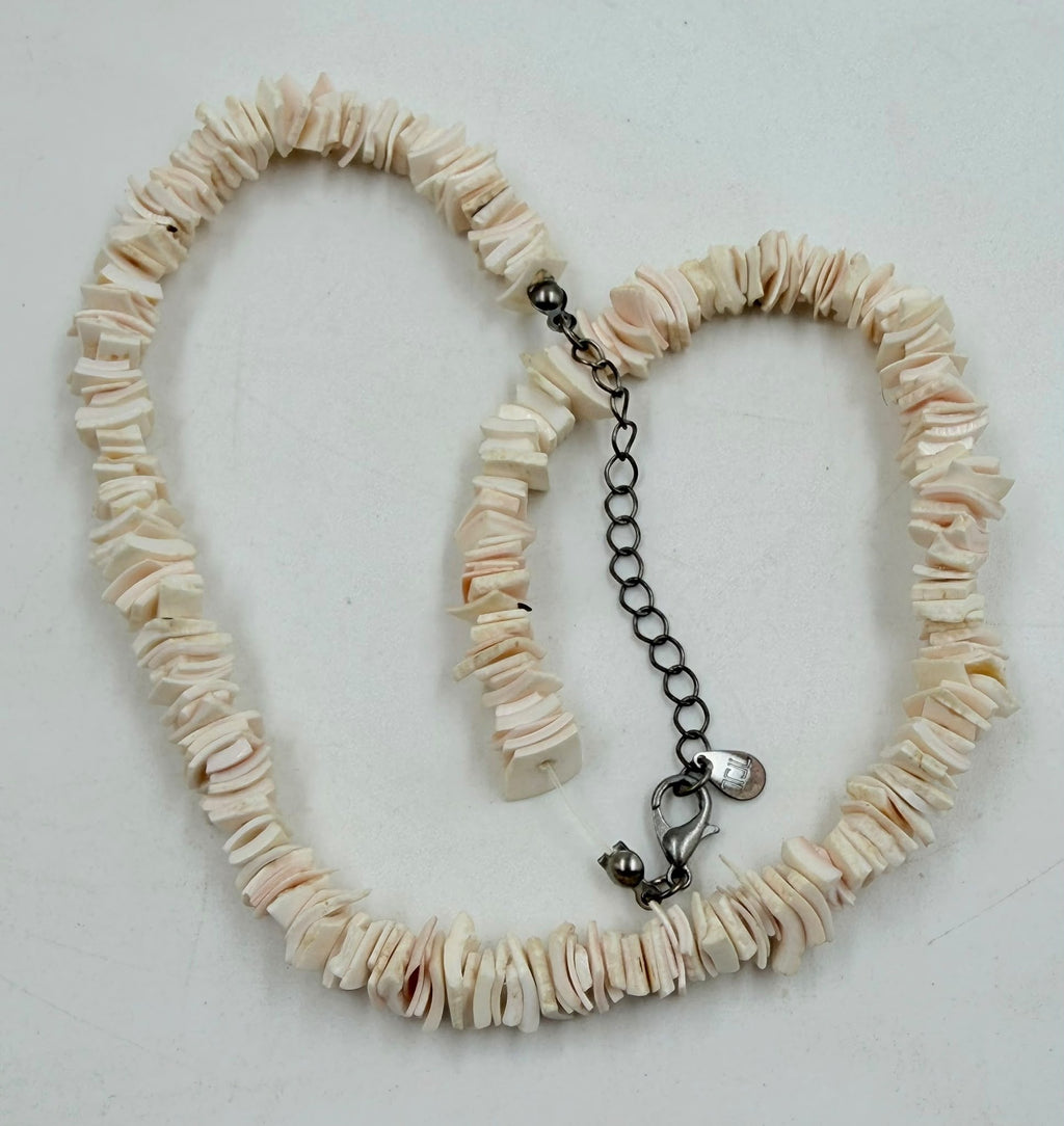 Pink shell slice necklace on jewelry display bust - full view
