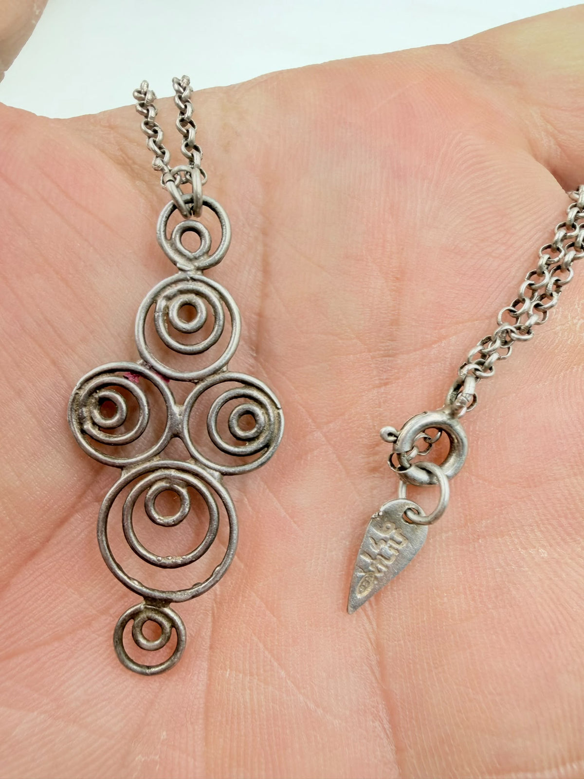 925 sterling silver Celtic spiral pendant in hand showing full design