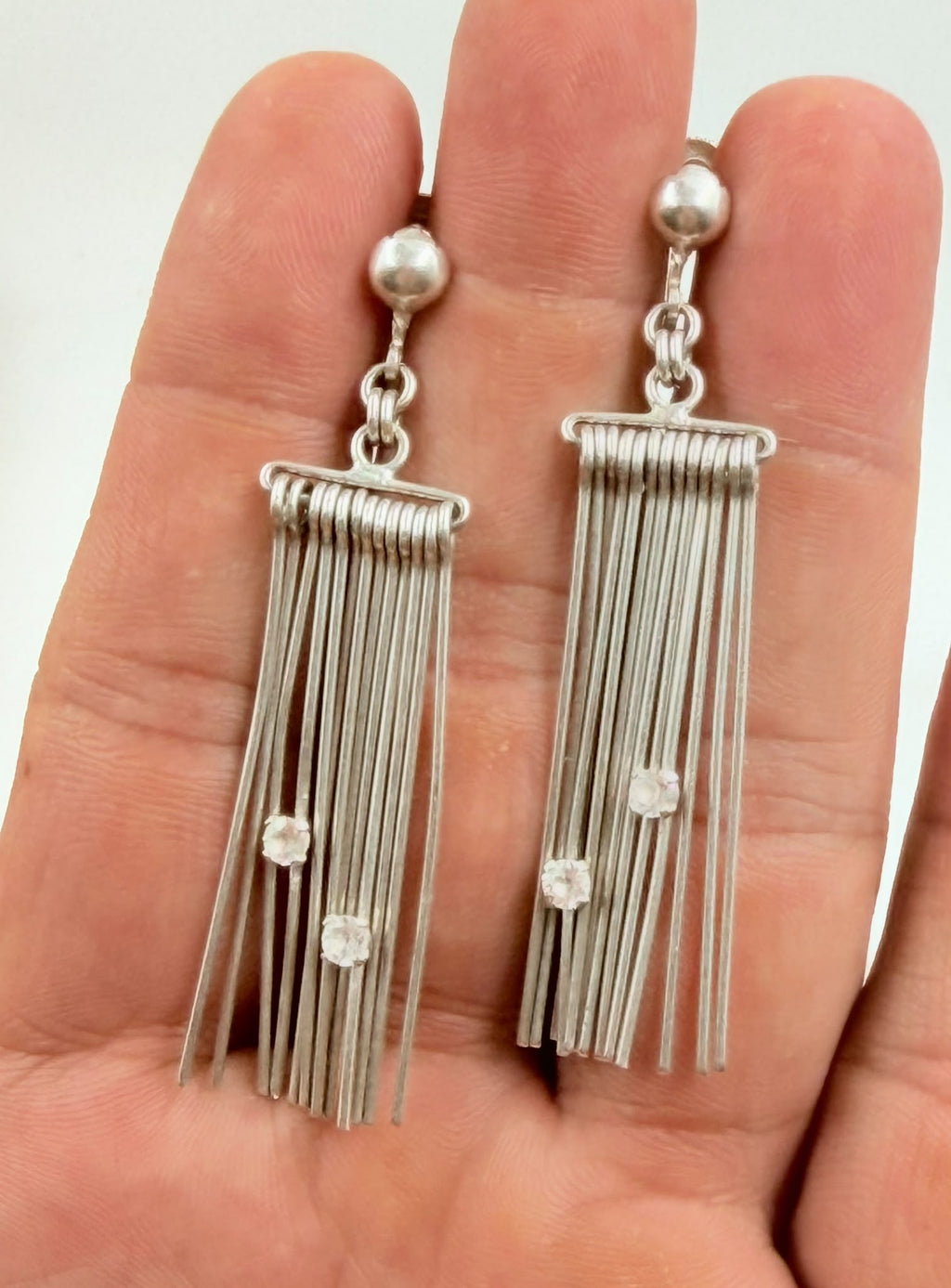 Earrings held in hand showing size and wire detail