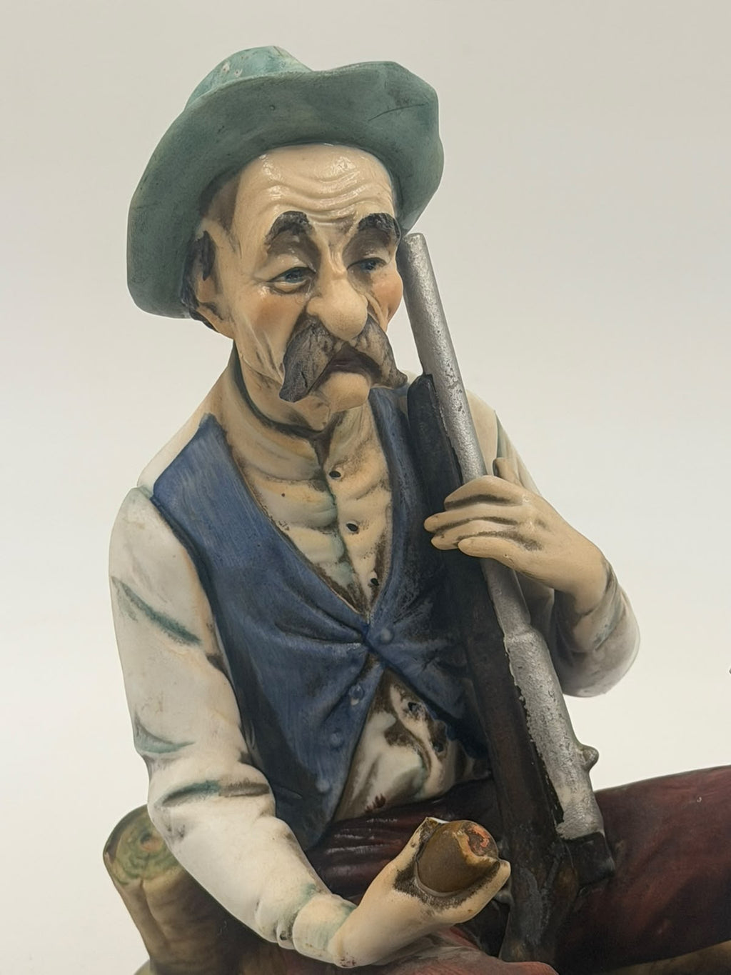 Vintage Capodimonte flute player figurine close-up of repaired hand detail