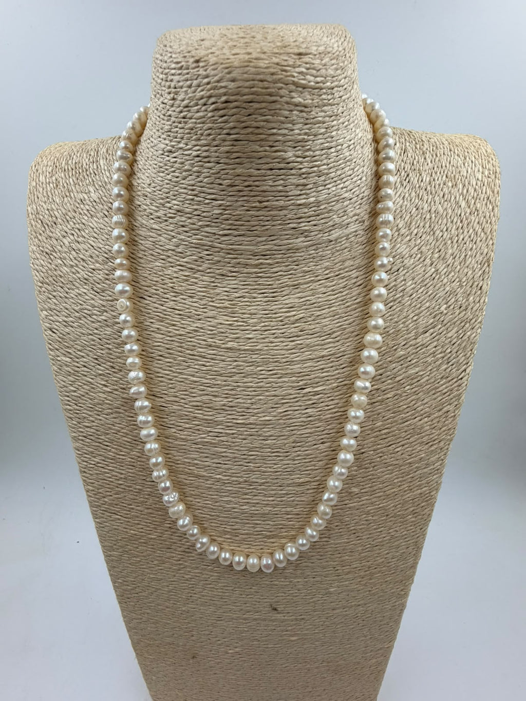Side view of freshwater pearl necklace showing bead size 5mm and lobster clasp metal finish
