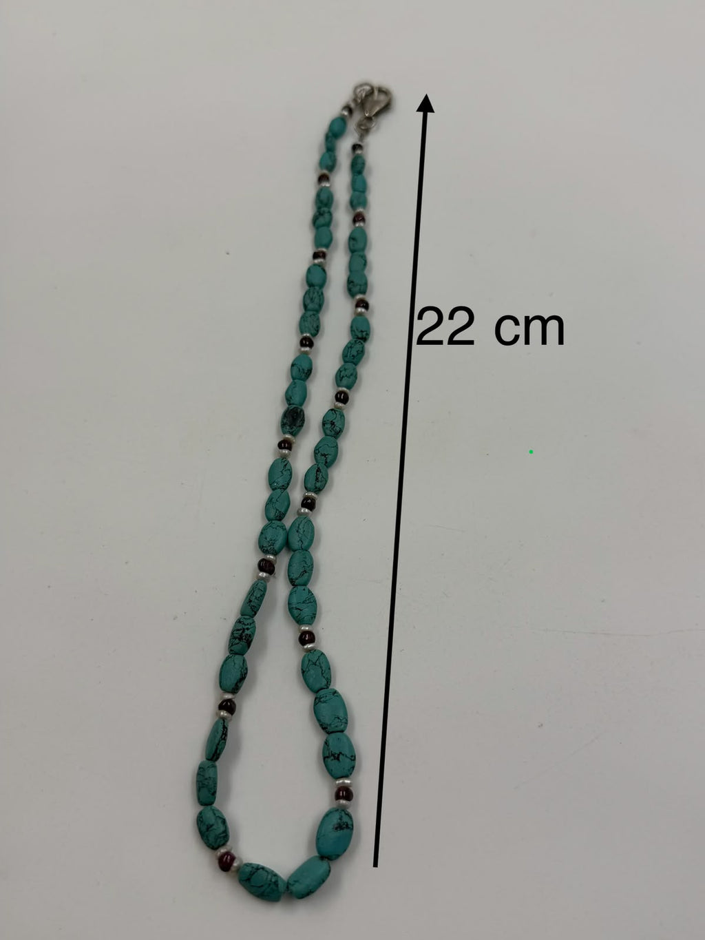 Natural turquoise garnet pearl necklace flat lay on white showing clasp and full length