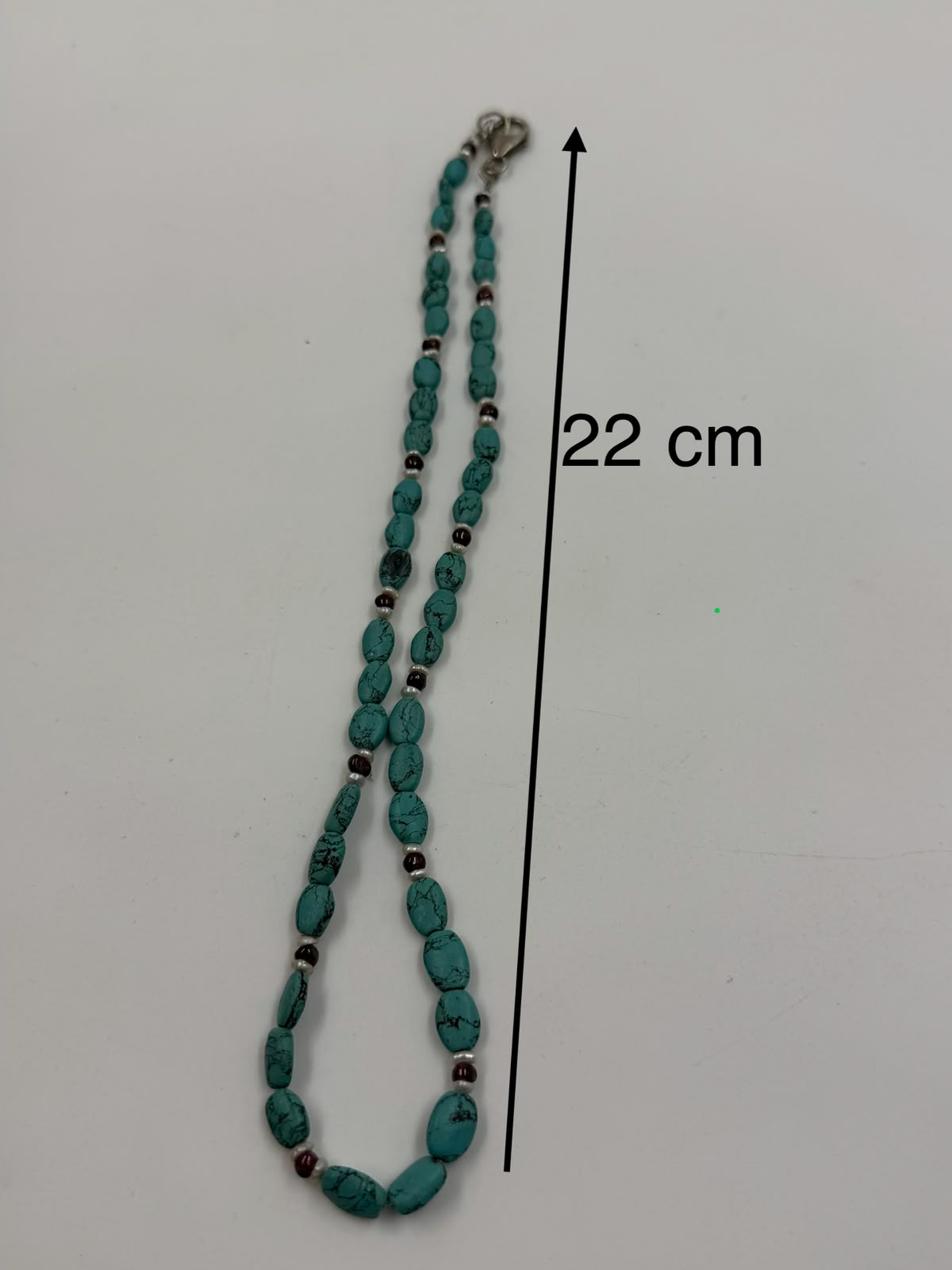 Natural turquoise garnet pearl necklace flat lay on white showing clasp and full length