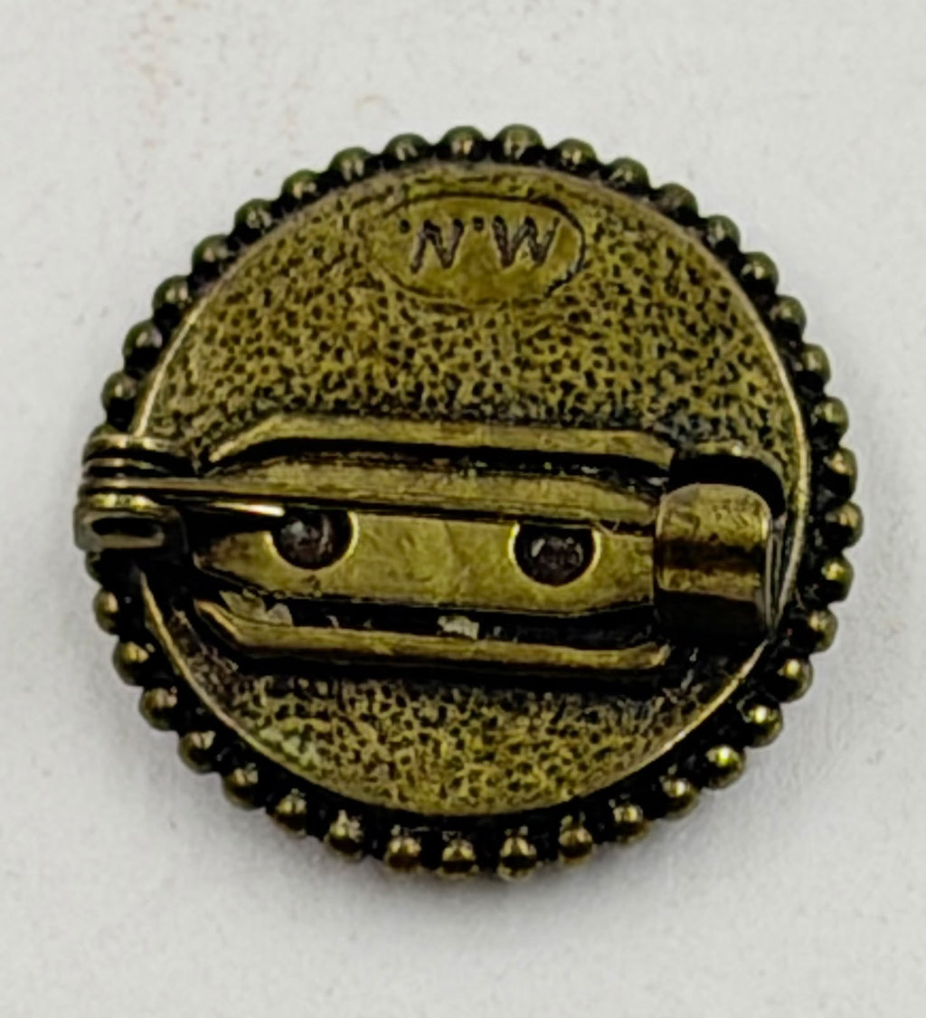 Back of brooch showing NW maker mark and pin clasp