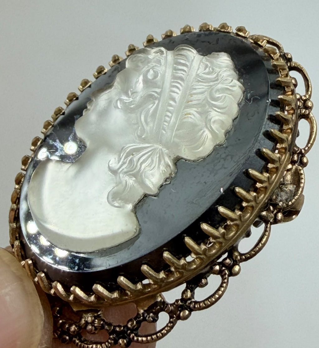 Cameo brooch on woven background