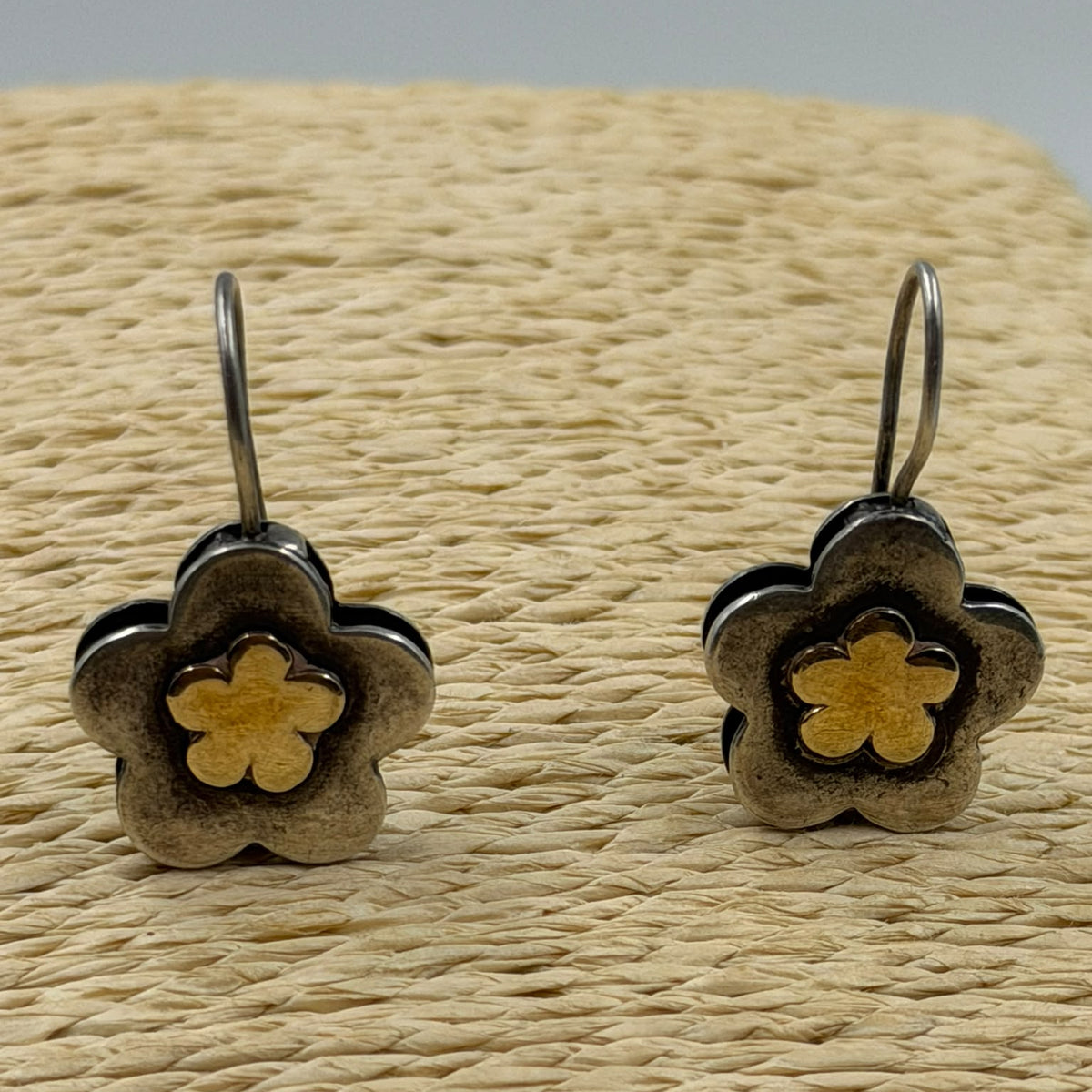 925 silver flower earrings DIANE on woven display showing warm gold plated centers