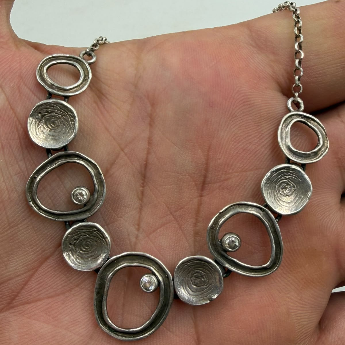 Detailed close-up of hallmark tag and spring ring clasp