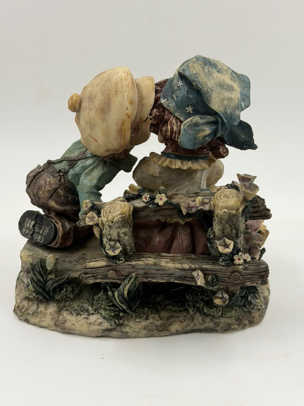 Vintage Victorian resin couple figurine back view showing log bench