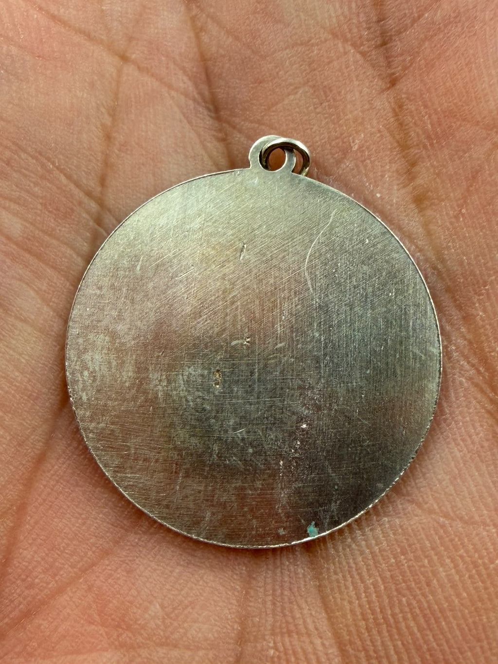 Pendant next to ruler showing 23mm diameter