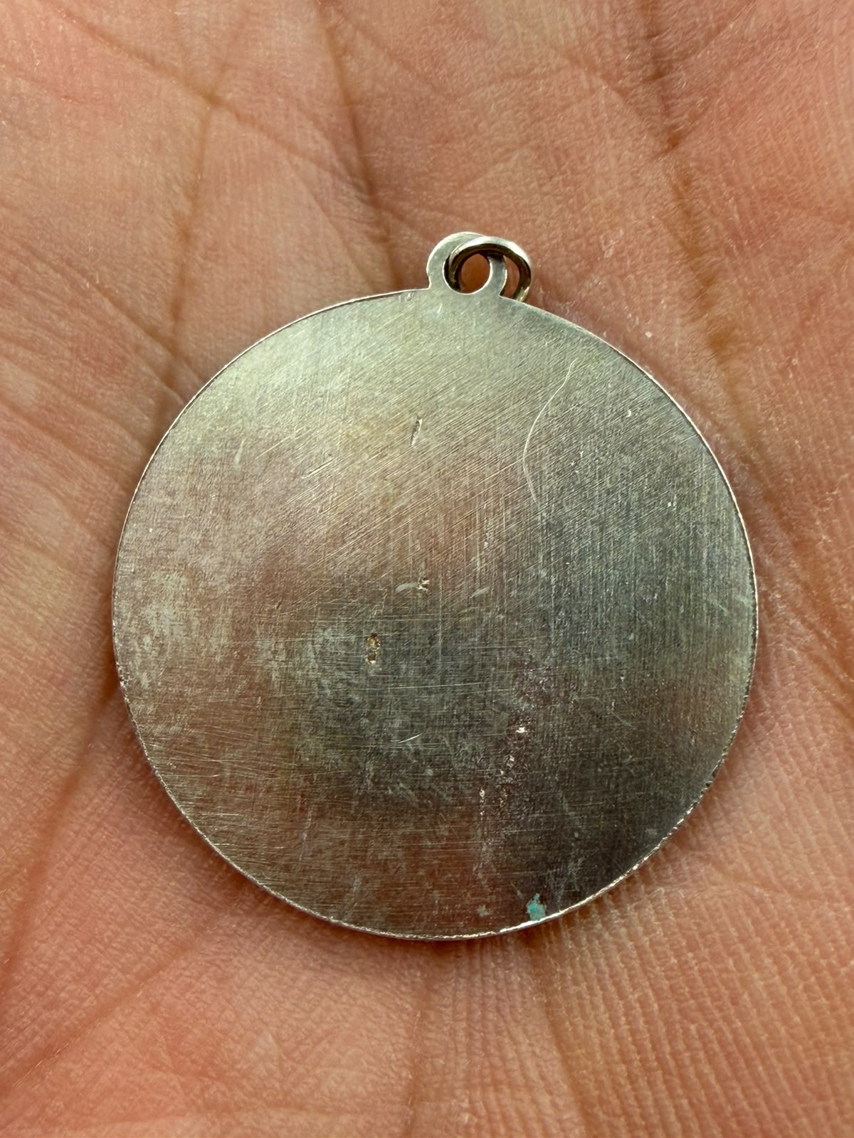 Pendant next to ruler showing 23mm diameter