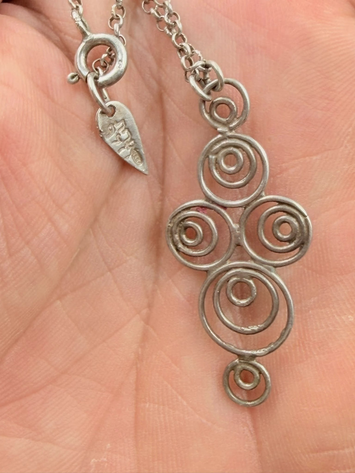 925 sterling silver Celtic spiral pendant and rolo chain in hand